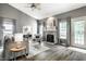 Comfortable living room with a fireplace, lots of natural light, and neutral color palette at 5883 Hollow Oak, Carmel, IN 46033