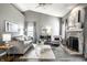 Stylish living room with a fireplace, plush sofa, and elegant decor, perfect for relaxation at 5883 Hollow Oak, Carmel, IN 46033