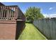 Backyard view of the deck extending alongside a lawn with a wood fence at 6027 Crystal View Dr, Indianapolis, IN 46237