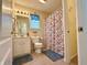 Well-maintained bathroom features a shower/tub combo and vanity with a floral shower curtain at 6027 Crystal View Dr, Indianapolis, IN 46237