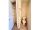 Cozy water closet features a toilet and built-in linen closet for easy storage at 6027 Crystal View Dr, Indianapolis, IN 46237