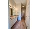 A bathroom featuring a vanity with white cabinets and stone countertops and wood flooring at 6027 Crystal View Dr, Indianapolis, IN 46237