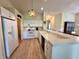Bright kitchen with white cabinets, modern appliances, and an adjacent dining area at 6027 Crystal View Dr, Indianapolis, IN 46237