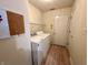 Bright laundry room with modern washer, dryer, and bulletin board at 6027 Crystal View Dr, Indianapolis, IN 46237