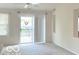 Bright living room featuring sliding door access to outdoor deck and neutral decor at 6027 Crystal View Dr, Indianapolis, IN 46237