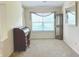 Bright living room featuring neutral walls, plush carpet, and bright window at 6027 Crystal View Dr, Indianapolis, IN 46237