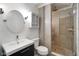 Modern bathroom with glass shower stall, vanity sink, and round mirror at 648 Shakespeare Dr, Avon, IN 46123