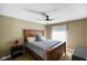 Neutral bedroom with wood trim bed frame, ceiling fan and good natural light at 648 Shakespeare Dr, Avon, IN 46123