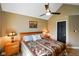 Cozy bedroom with a patterned quilt, wood furnishings, and black paneled door at 648 Shakespeare Dr, Avon, IN 46123