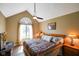 Bedroom features a vaulted ceiling, fan, and large window with a decorative transom at 648 Shakespeare Dr, Avon, IN 46123