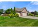 Well-maintained brick home featuring a three-car garage and lush landscaping, offering great curb appeal at 648 Shakespeare Dr, Avon, IN 46123