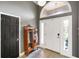 Bright foyer with tiled floors, a decorative cabinet, and natural light streaming in through the doorway at 648 Shakespeare Dr, Avon, IN 46123