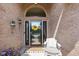 Elegant front door with sidelights, a decorative wreath, and stylish sconces, creating a warm welcome at 648 Shakespeare Dr, Avon, IN 46123