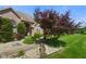 Beautifully landscaped front yard with a charming walkway, mature trees, and decorative stone accents at 648 Shakespeare Dr, Avon, IN 46123