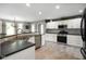 Modern kitchen features white cabinets, mosaic tile backsplash and tile flooring at 648 Shakespeare Dr, Avon, IN 46123