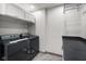 Laundry room with front loading washer and dryer, overhead cabinets, and counter at 648 Shakespeare Dr, Avon, IN 46123