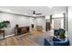 Spacious living room features ceiling fan, hardwood floors and blue accent chairs at 648 Shakespeare Dr, Avon, IN 46123