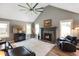 Comfortable living room with fireplace, television, and large windows for ample light at 648 Shakespeare Dr, Avon, IN 46123
