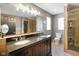 Main bathroom boasts a dual sink vanity, glass shower and walk-in closet at 648 Shakespeare Dr, Avon, IN 46123