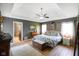 Relaxing main bedroom features tray ceilings, a cozy rug, and ensuite bathroom access at 648 Shakespeare Dr, Avon, IN 46123