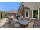 Outdoor patio with stone table, umbrella, and comfortable seating area for relaxing and entertaining at 648 Shakespeare Dr, Avon, IN 46123
