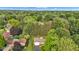 A vibrant canopy of trees surrounds a cozy house nestled into a mature neighborhood at 703 Chapel Hill W Dr, Indianapolis, IN 46214