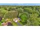 An aerial view showing the property among lush trees and the neighborhood at 703 Chapel Hill W Dr, Indianapolis, IN 46214
