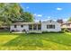 Large backyard with a well-manicured lawn and a cozy sunroom at 703 Chapel Hill W Dr, Indianapolis, IN 46214