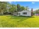 Expansive backyard features lush greenery, mature trees, and a sunroom at 703 Chapel Hill W Dr, Indianapolis, IN 46214