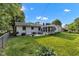 Spacious backyard with a well-maintained lawn and an outdoor seating area at 703 Chapel Hill W Dr, Indianapolis, IN 46214