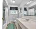 Bright bathroom features modern fixtures, a large mirror, and a shower-tub combo at 703 Chapel Hill W Dr, Indianapolis, IN 46214