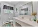 Bright bathroom features modern fixtures, a large mirror, and a shower-tub combo at 703 Chapel Hill W Dr, Indianapolis, IN 46214
