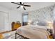 Cozy bedroom features hardwood floors, floral wallpaper, and a modern ceiling fan at 703 Chapel Hill W Dr, Indianapolis, IN 46214