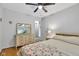 Comfortable bedroom with wooden floors, a ceiling fan, and a vintage dresser at 703 Chapel Hill W Dr, Indianapolis, IN 46214