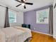 Cozy bedroom with hardwood floors, desk, and ample natural light at 703 Chapel Hill W Dr, Indianapolis, IN 46214