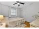 Bedroom showcasing hardwood floors, closet space, and bright, natural light at 703 Chapel Hill W Dr, Indianapolis, IN 46214
