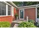 Charming brick home featuring a well-decorated front door and landscaped yard at 703 Chapel Hill W Dr, Indianapolis, IN 46214