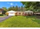 Charming red brick home with a well-manicured lawn and attached garage, creating a welcoming curb appeal at 703 Chapel Hill W Dr, Indianapolis, IN 46214