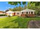 Well-maintained front yard with a classic red brick home, attached garage, and lush landscaping, creating curb appeal at 703 Chapel Hill W Dr, Indianapolis, IN 46214