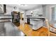Well-maintained kitchen with white cabinets, black appliances, and wood floors at 703 Chapel Hill W Dr, Indianapolis, IN 46214
