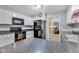 The kitchen features modern appliances, white cabinetry and black countertop, offering a blend of style and functionality at 703 Chapel Hill W Dr, Indianapolis, IN 46214