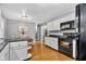 Cozy kitchen features bright white cabinets, modern appliances, and a delightful breakfast nook for casual dining at 703 Chapel Hill W Dr, Indianapolis, IN 46214