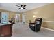 A relaxed living room showcases natural light, a ceiling fan, and cozy seating perfect for entertaining or relaxing at 703 Chapel Hill W Dr, Indianapolis, IN 46214