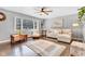 Comfortable living room features hardwood floors, neutral paint, and a ceiling fan at 703 Chapel Hill W Dr, Indianapolis, IN 46214