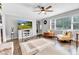 Spacious living room with hardwood floors, ceiling fan, and large windows for plenty of natural light at 703 Chapel Hill W Dr, Indianapolis, IN 46214