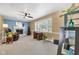 Comfortable living room features a ceiling fan, a cozy fireplace, and natural light creating a welcoming space at 703 Chapel Hill W Dr, Indianapolis, IN 46214