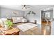 Bright and airy living room with hardwood floors, a ceiling fan, and a view into the dining room at 703 Chapel Hill W Dr, Indianapolis, IN 46214