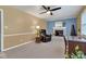 Comfortable living room features a ceiling fan, a cozy fireplace, and natural light creating a welcoming space at 703 Chapel Hill W Dr, Indianapolis, IN 46214