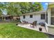 Charming backyard patio with comfortable seating surrounded by a lush green lawn at 703 Chapel Hill W Dr, Indianapolis, IN 46214