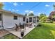 Cozy backyard patio with ample seating and a sunroom, perfect for outdoor relaxation at 703 Chapel Hill W Dr, Indianapolis, IN 46214